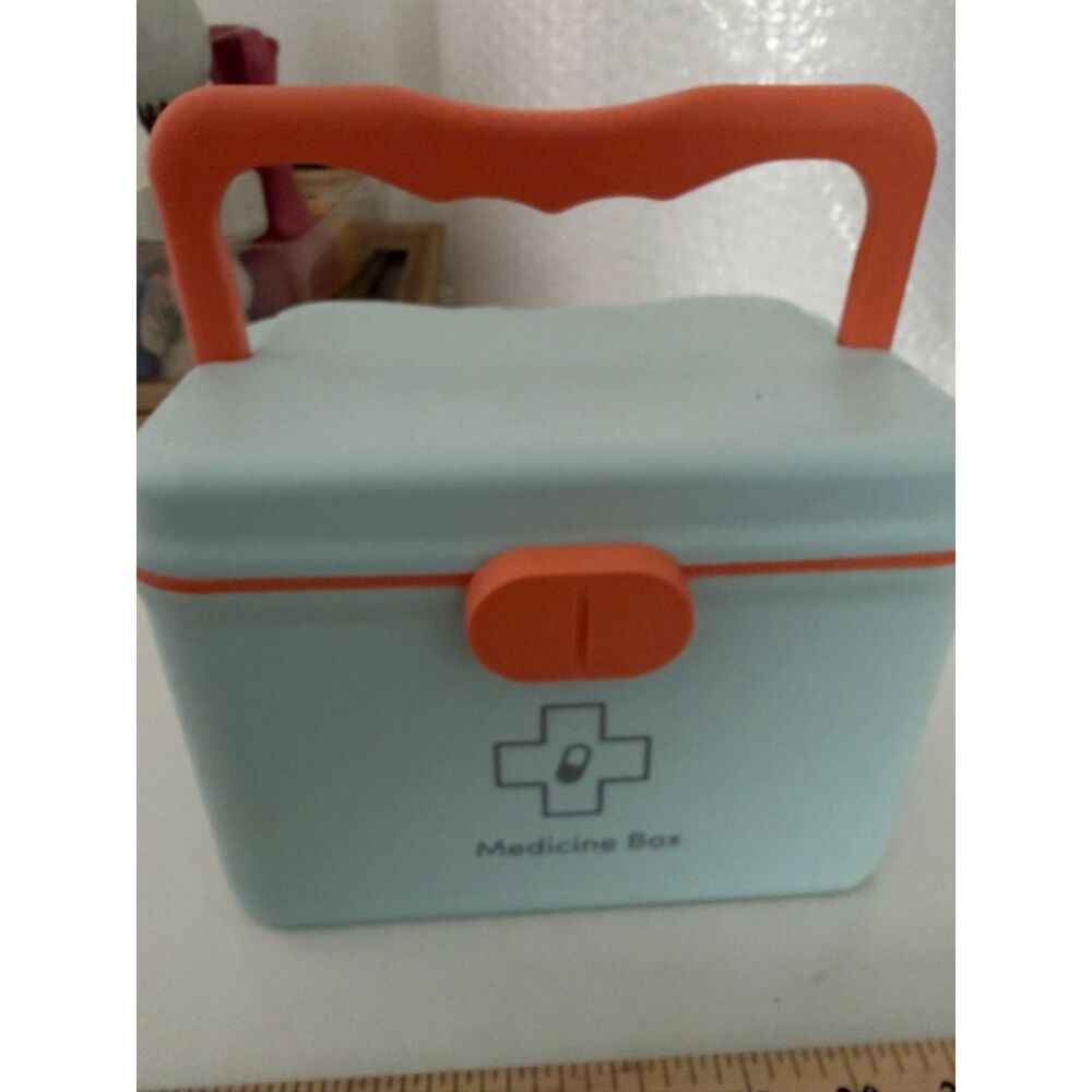 Modern portable plastic medicine box with orange handle and latch